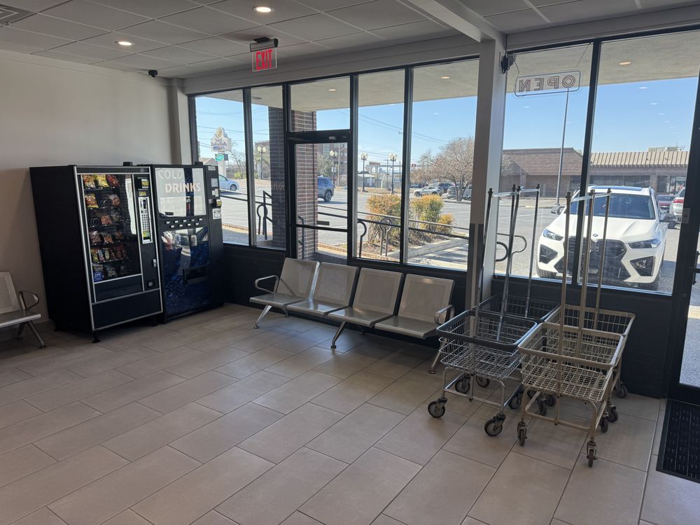 Bright, spacious lobby with seating, laundry carts, and vending at Retro Laundry Co. in San Antonio
